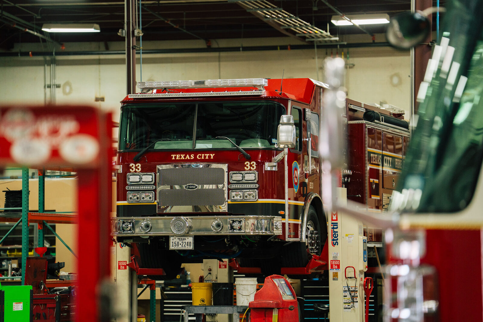 Texas City fire engine up on the lift inside the FESFAB shop
